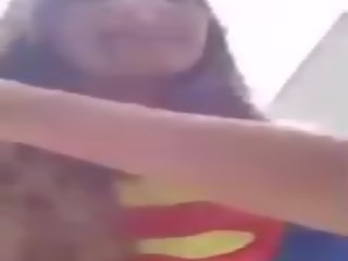 Trisha Annabelle Smoking in Superman Outfit Outside.